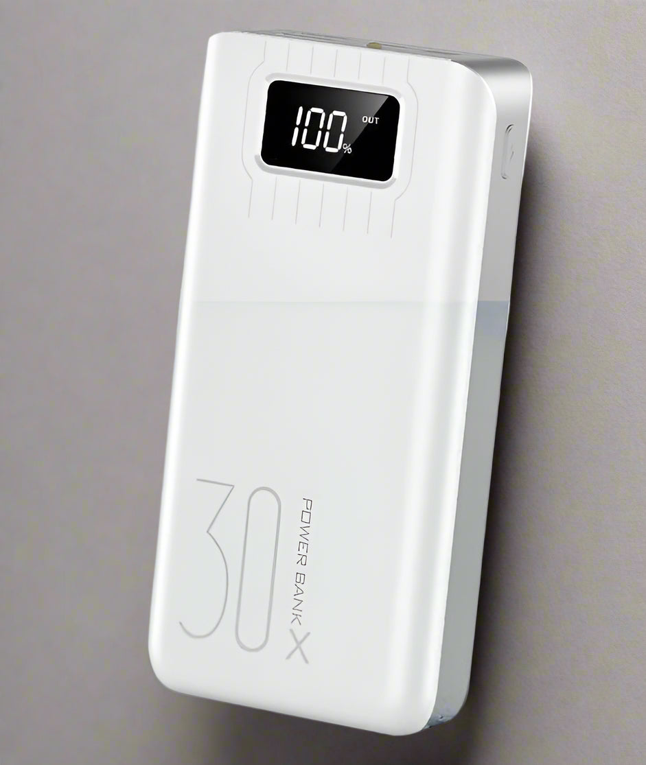 White power bank with digital display on a light  background