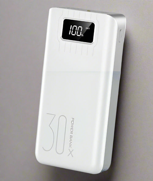 White power bank with digital display on a light  background